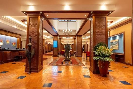 Grand hotel lobby with polished floors and chandelier