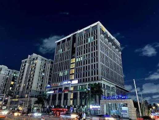 Modern city hotel tower lit up at night