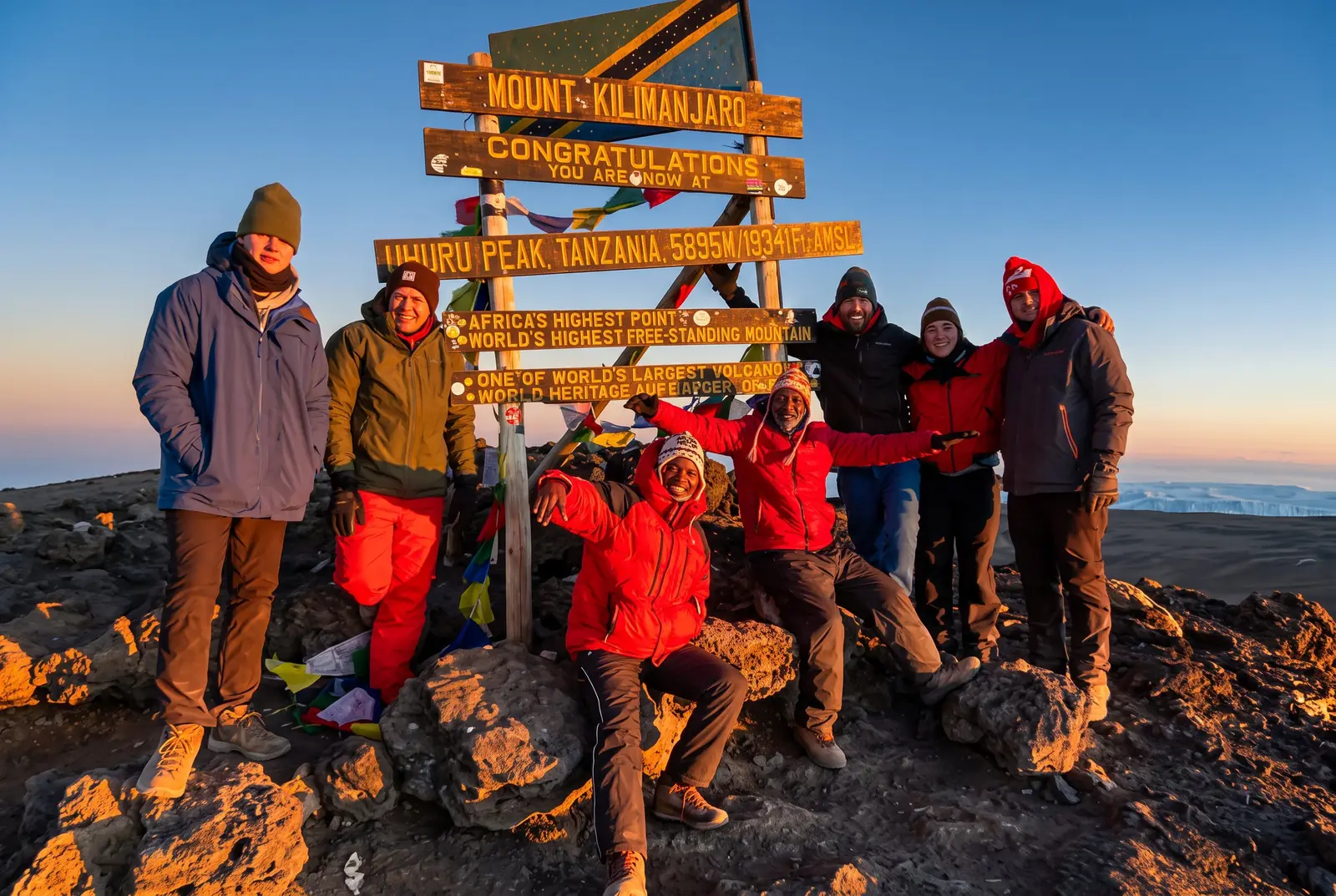 Trekkers celebrating at Uhuru Peak, Mount Kilimanjaro